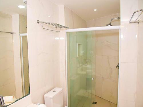 y baño con ducha de cristal y aseo. en Porto Beach Resort - Marulhos, en Porto de Galinhas