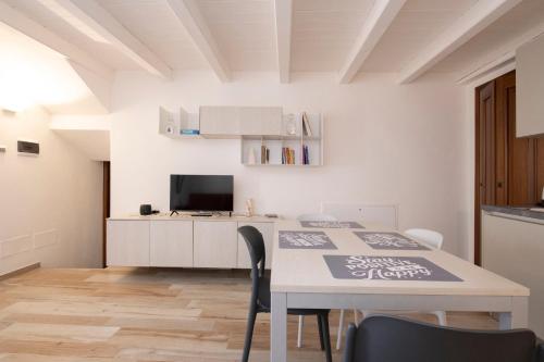 a kitchen and dining room with a table and chairs at Maison Croix de Ville in Aosta