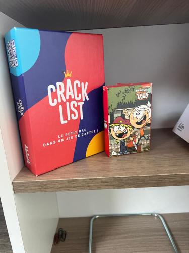 two books are sitting on a shelf at Bel appartement lumineux 35m2, Bord De Loire in Saint-Jean-le-Blanc