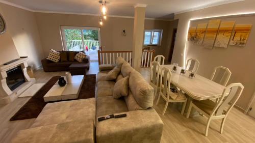 a living room with a couch and a table at Varandas de Troia in Troia