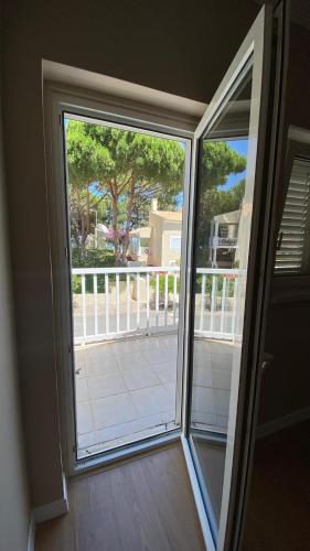 a sliding glass door with a view of a porch at Varandas de Troia in Troia