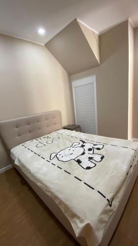 a large bed in a bedroom with a white bedspread at Varandas de Troia in Troia