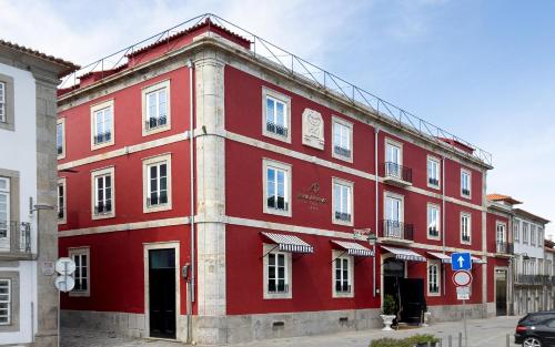 a red building on the side of a street at AP Dona Aninhas in Viana do Castelo