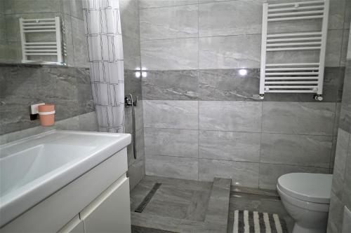 y baño con lavabo blanco y aseo. en Bright and cozy apartment nr. 1, en Chişinău