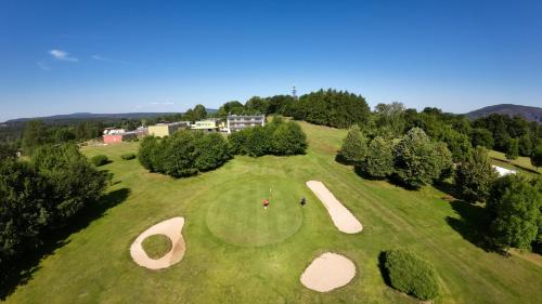 an overhead view of a golf course with people on the green at Penzion Pod Devítkou in Hřensko