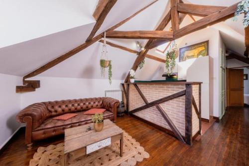 a living room with a couch and a table at Manoir d'Egrefin in Saint-Martin-dʼAbbat