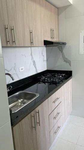 a kitchen with a sink and a stove at Apartamento muy cerca al Mar!-0k in Cartagena de Indias