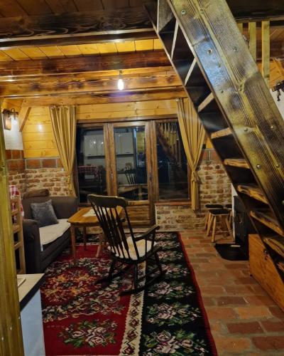 a living room with a staircase and a couch at Vikendica Tromedja Pale in Pale