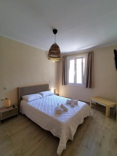 a bedroom with a large bed with towels on it at Zante Ionian City House in Zakynthos Town