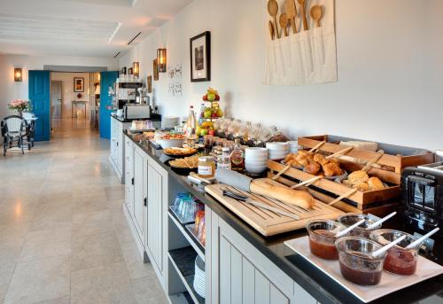 a kitchen with a counter with bread and other foods at La Bastide de Biot in Biot
