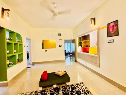 a large living room with a couch and a table at Crossroads Hostel 1980 in Mysore