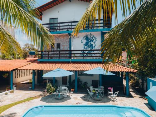 a resort with a swimming pool and a building at Pousada São Jorge in Porto De Galinhas