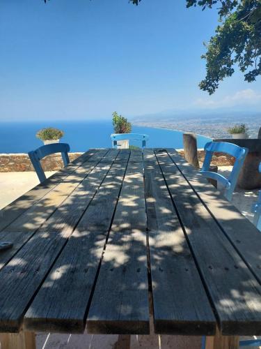a wooden table with two benches on the beach at Athene place 1 in Rodhiá