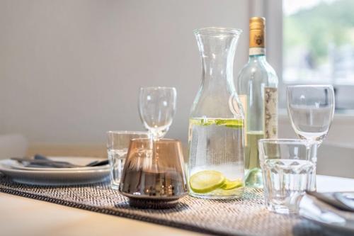 a table with glasses and a bottle of wine at Weitblick in Breitnau