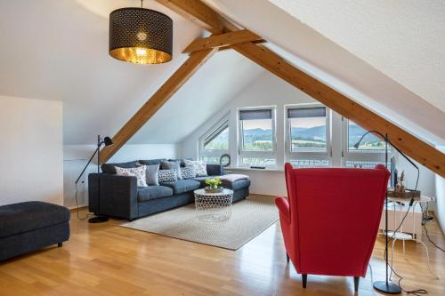 a living room with a couch and a chair at Weitblick in Breitnau