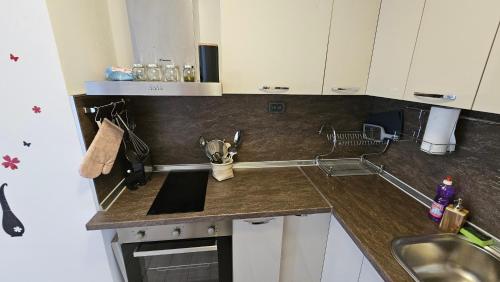 a kitchen with a sink and a counter top at Kros Properties - Central in Varna City