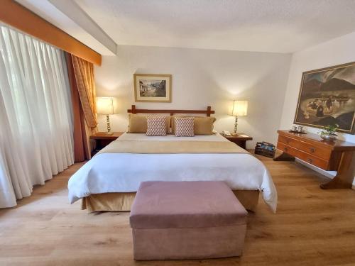 a bedroom with a large bed and a large window at Antara Hotel & Suites - Miraflores in Lima