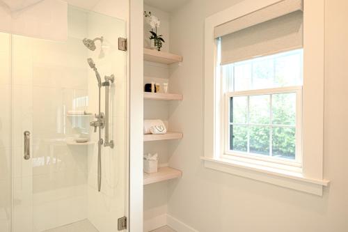 a bathroom with a shower and a window at Grasshopper Inn in Ogunquit