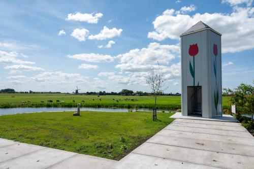 a monument with a flower painted on it on a field at 4 to 6 persons waterfront villa in Roelofarendsveen