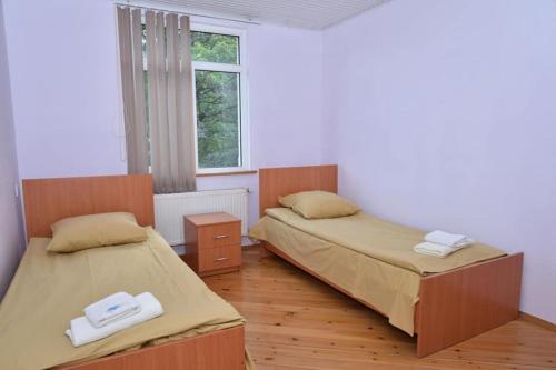 a bedroom with two beds and a window at Grand Village in İsmayıllı