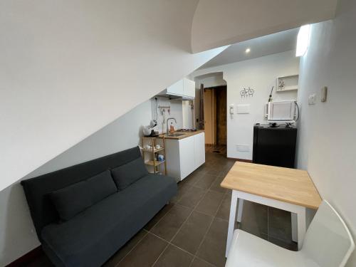 a living room with a couch and a kitchen at Happyhouse in Turin