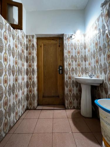 a bathroom with a sink and a toilet at WonderLand Guest House in Udhampur