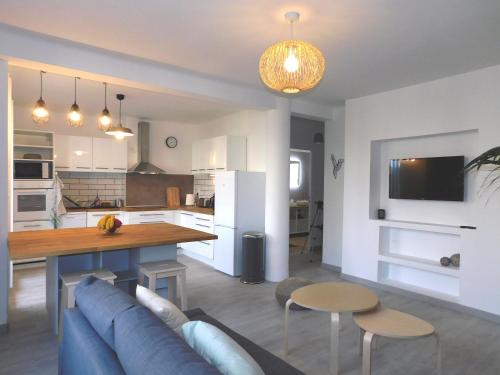 un salon avec un canapé bleu et une cuisine dans l'établissement Bel appartement 4 pièces, à Toulon
