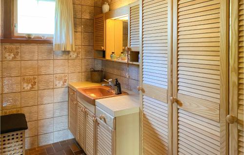 a small bathroom with a sink and a mirror at Beautiful Home In Frde With House A Panoramic View in Førde