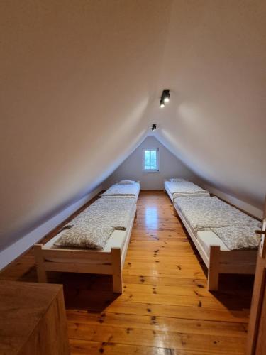 a room with two beds in a attic at Ostoja in Ostrowo