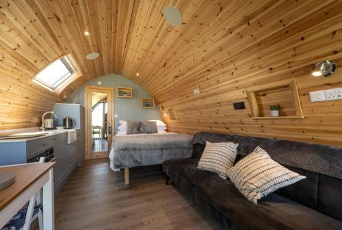 a living room with a couch and a bed at Macree Pod in Taynuilt