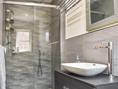 a bathroom with a sink and a shower at Centurion Rise in Penrith