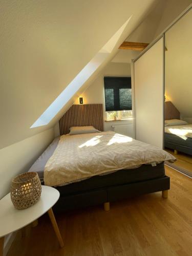 a attic bedroom with a bed and a table at Jelling in Jelling