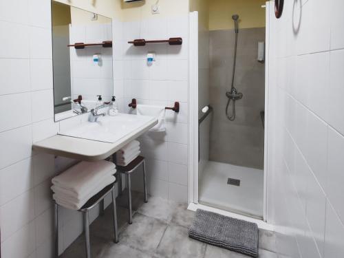 a white bathroom with a sink and a shower at Los Secretos de Lua 