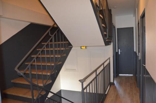 a staircase in a house with black and white walls at Résidence Zola in Le Havre