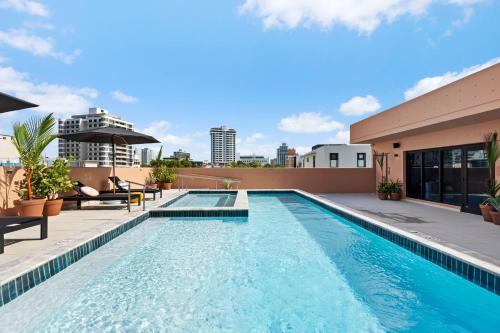 a swimming pool on the roof of a building at HiBird- Apartment and Suites Hotel in San Juan