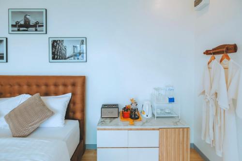 a bedroom with a bed with a nightstand next to it at ไนท์สกาย โฮมสเตย์ in Ban Mae Na