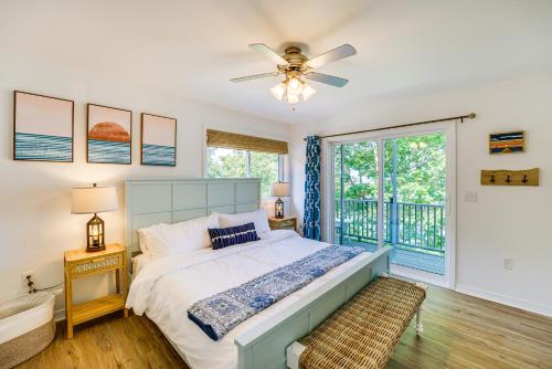 a bedroom with a bed with a ceiling fan at Private Beachfront Lake Michigan Rental with Kayaks in Pentwater