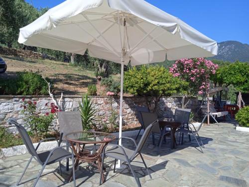 a table and chairs under an umbrella on a patio at Nemesis in Neo Klima