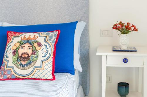 a bed with a pillow with a sombrero at Zagara e Sirene in Amalfi