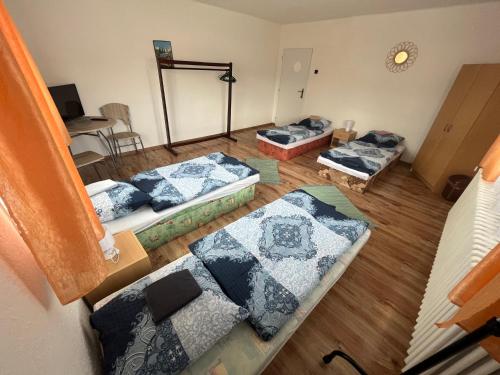 an overhead view of a room with three beds at Turistická ubytovňa u Frajta in Telgárt