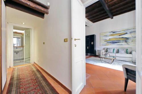 an open hallway with a living room with a couch at Leonina4 Cozy Apartment in Rome
