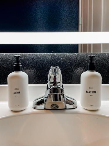 three bottles ofodorizers sitting on a bathroom sink at Dolly's Glam Getaway - Glittering Gem Near Broadway in Nashville