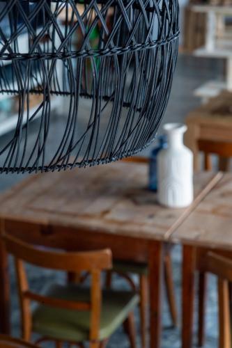 a basket on top of a wooden table with a chair at Hostal Boutique Es Menut in Tossa de Mar
