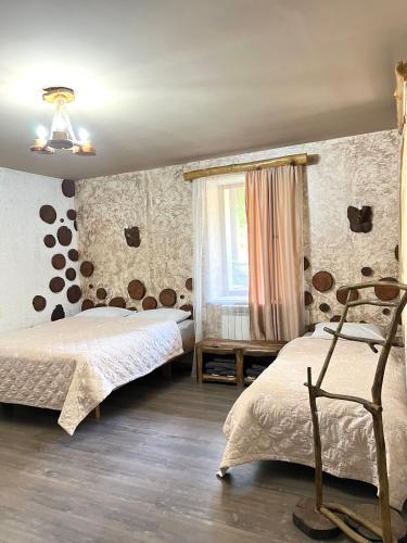 a bedroom with two beds and a window at ARTSIV Guesthouse in Dilijan