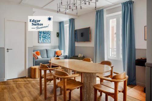 een woonkamer met een tafel en stoelen bij Edgar Suites Montmartre - Paul Albert in Parijs