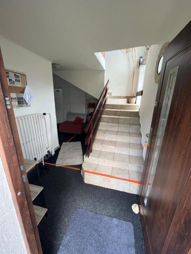 an empty hallway with stairs and a stair case at Turistická ubytovňa u Frajta in Telgárt