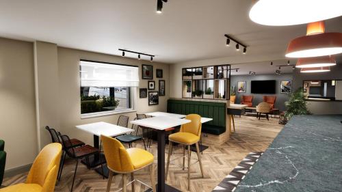 a restaurant with tables and chairs and a counter at Super 8 by Wyndham Chester East in Chester