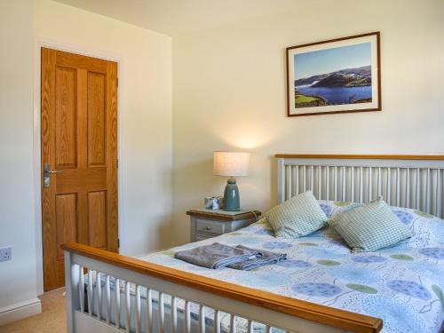 a bedroom with a bed with a blue comforter at Centurion Rise in Penrith