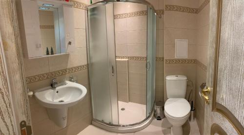 a bathroom with a shower and a toilet and a sink at Happy smiles in Pomorie
