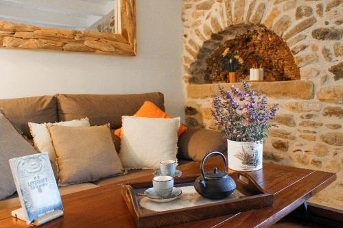 a living room with a couch and a table with flowers at MONELLS - CASA Rural - CAN FELIP in Monells